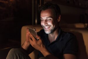 portrait-of-happy-mature-man-using-cell-phone-at-home.jpg